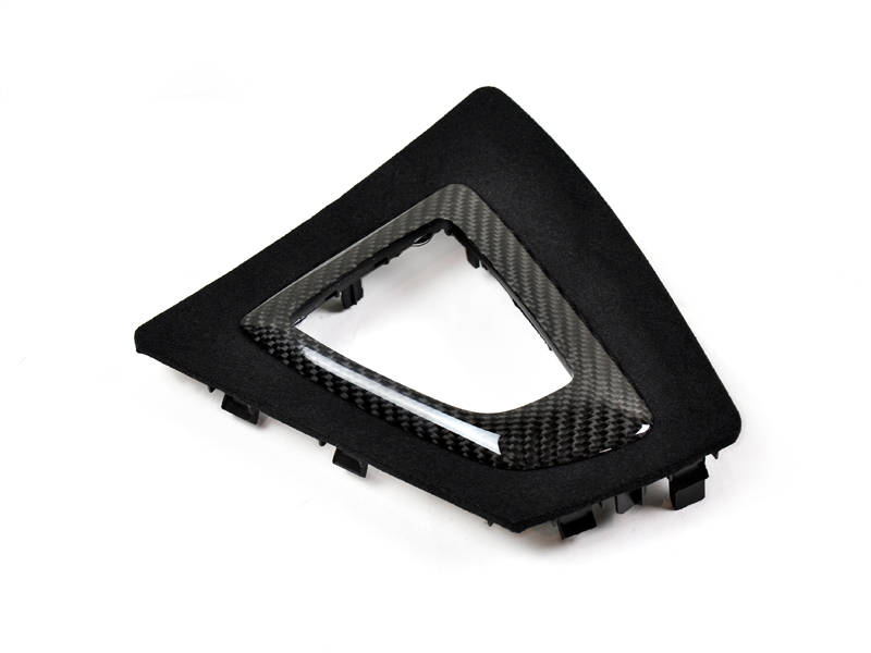 A black and carbon fiber AutoTecknic shift console trim designed for BMW vehicles, isolated on a white background.