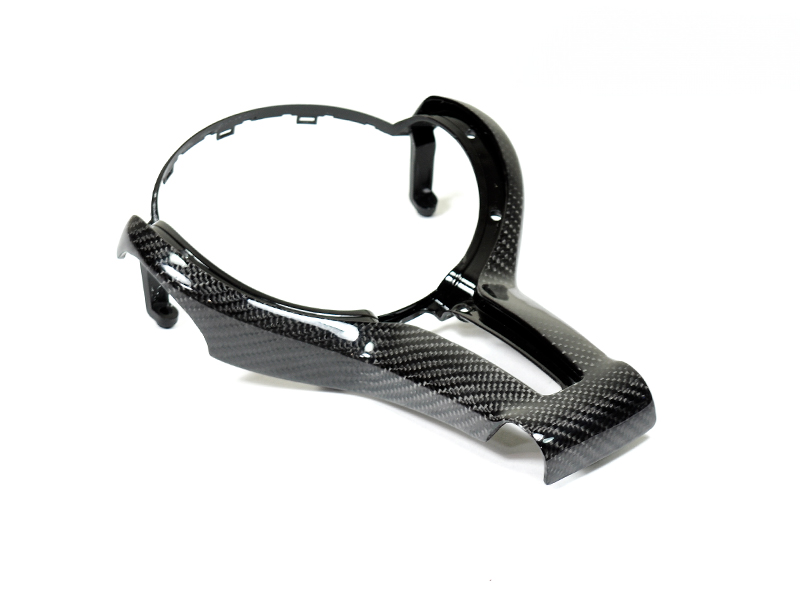 A carbon fiber outer steering wheel trim designed for specific F-Chassis BMW M vehicles.