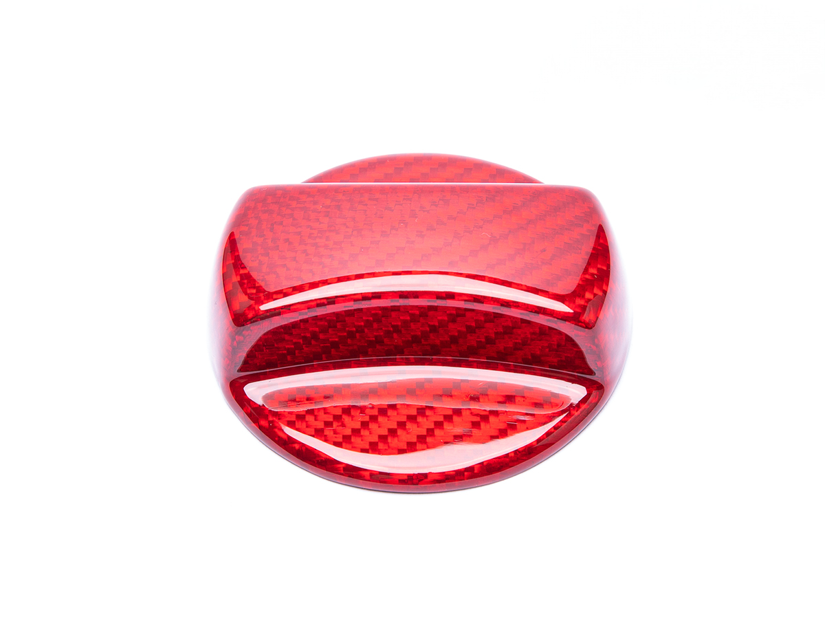 A red carbon fiber fuel cap cover for a BMW G20 3-Series.
