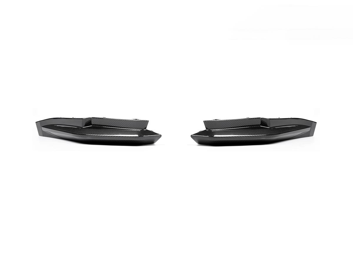 A set of two black carbon fiber rear side splitters for BMW M3 and M4 models.