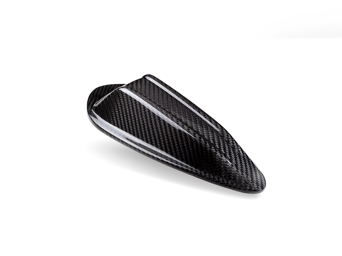 A black carbon fiber shark fin antenna cover with a precise carbon weave pattern.