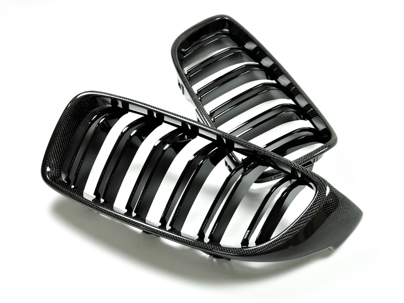 A pair of black dual-slat carbon fiber front grilles for BMW vehicles.