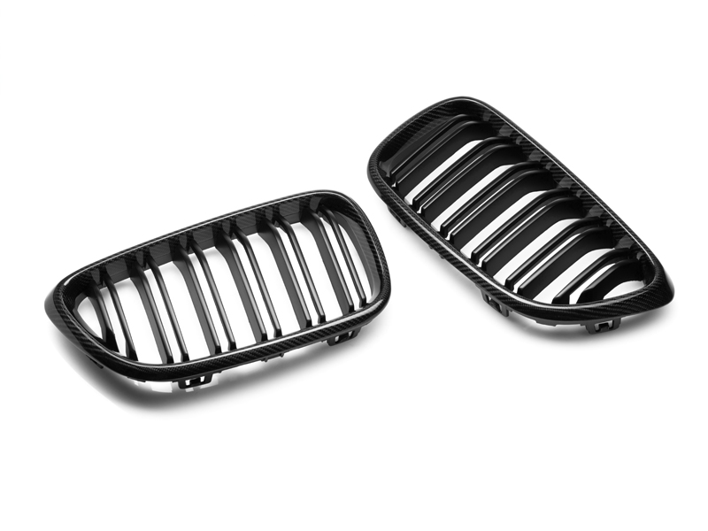A pair of black dual-slats carbon fiber front grilles for BMW vehicles.