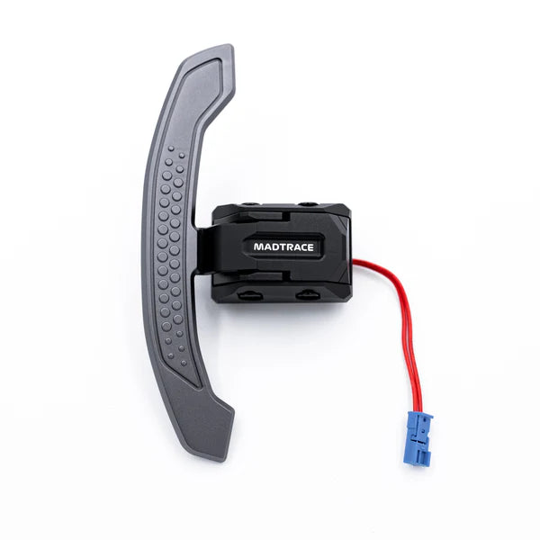 A JQ Werks Madtrace Clubsport Magnetic Paddle Shifter for BMW and Toyota vehicles, featuring a gray shifter with a carbon fiber inlay and a visible blue wire connector.