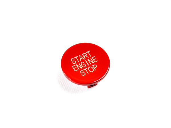 A red start stop button with the text 'START ENGINE STOP' on it, isolated on a white background.