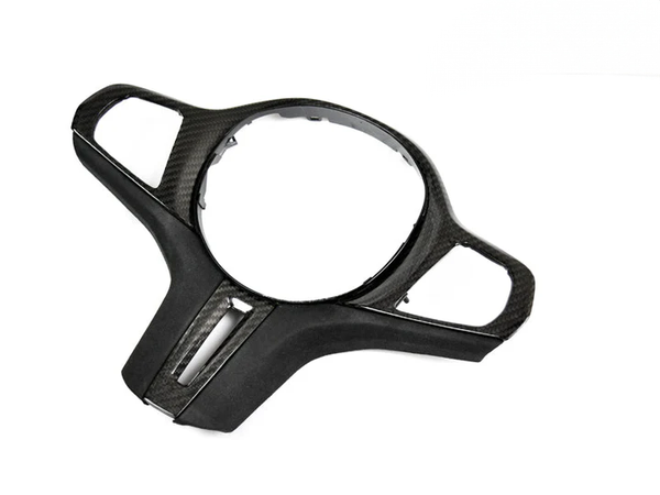A carbon fiber steering wheel trim with Alcantara material on the grip surface, designed for BMW G8X M2 / M3 / M4 models.