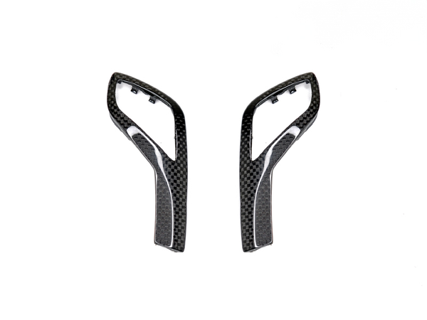 A pair of carbon fiber gear selector side trims designed for G20 3-Series vehicles.