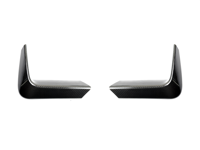 A pair of AutoTecknic carbon fiber rear bumper trims with a twill weave pattern, designed for BMW M3 and M4 models.