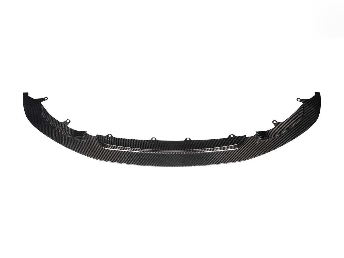 A black carbon fiber front aero lip for BMW vehicles.