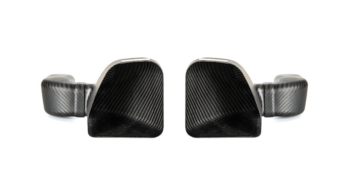 A pair of carbon fiber intake air ducts designed for specific BMW models.