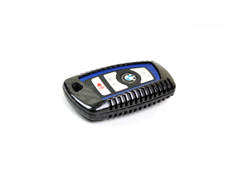 A black and blue carbon fiber remote key case for BMW vehicles on a white background.