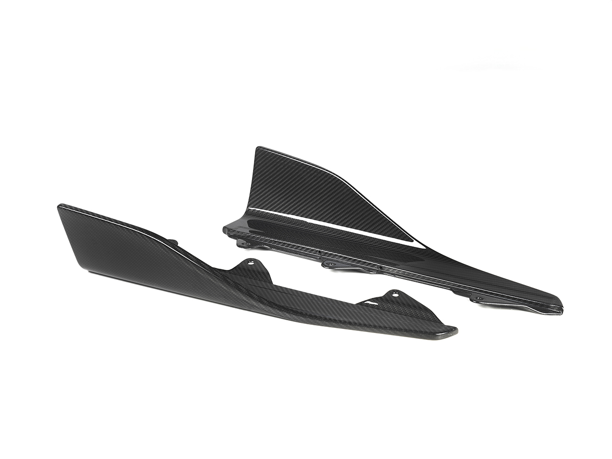 A set of black carbon fiber side skirt winglets designed for the BMW F87 M2.