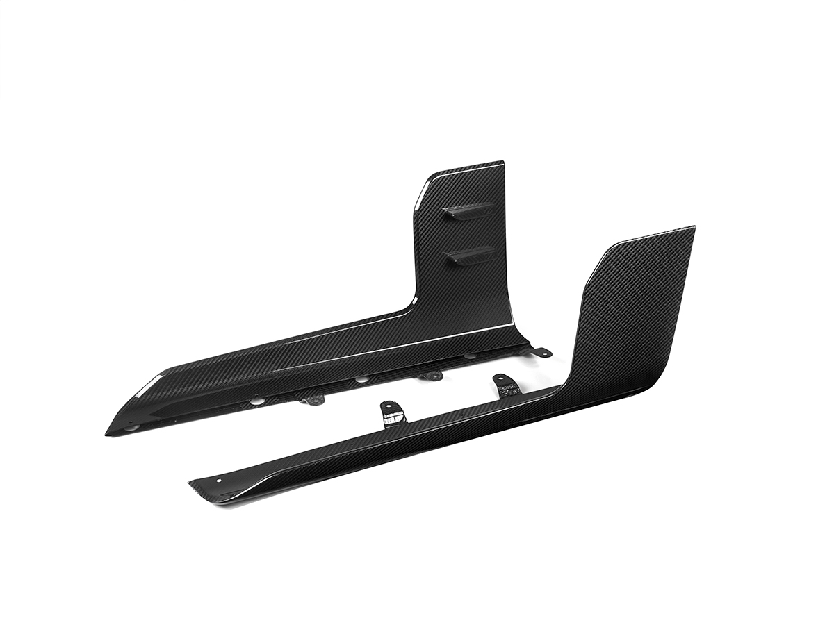 A set of black carbon fiber side skirt winglets for the BMW G87 M2.