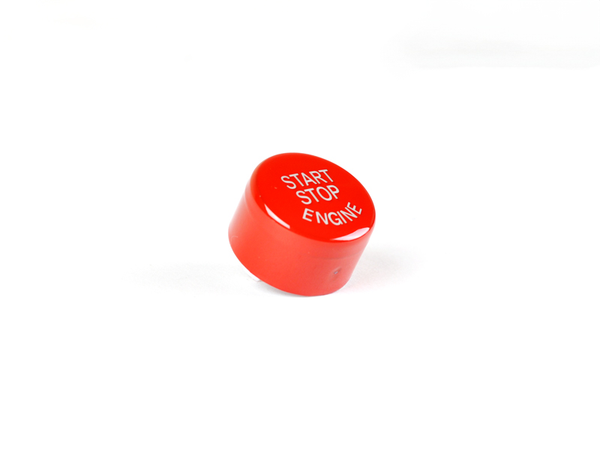 A bright red start stop button for a vehicle, with 'START STOP ENGINE' text visible.