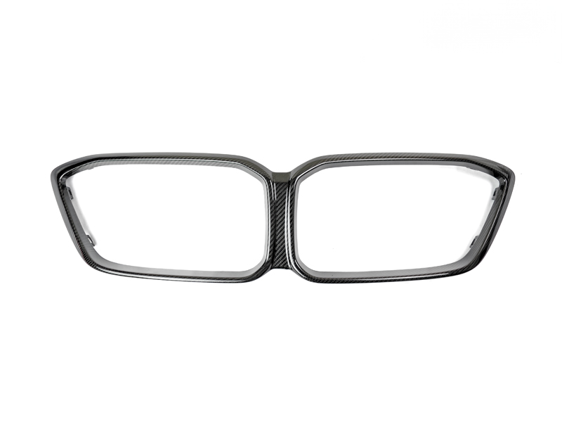 A set of two dry carbon grille surrounds for a BMW M2 Competition, showing a precision fit design with no chrome and a sleek black appearance.