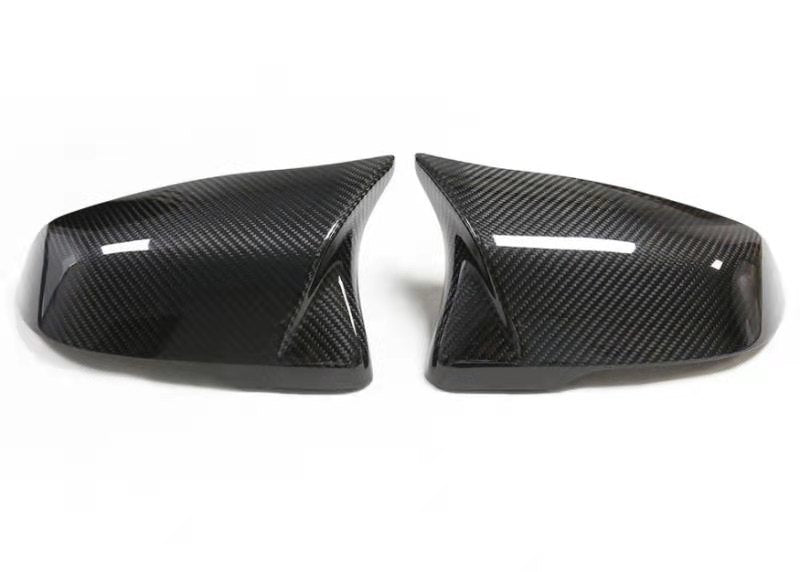 A pair of carbon fiber mirror covers for an A90 Supra.
