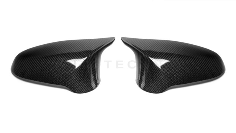 A pair of carbon fiber mirror covers for BMW vehicles.