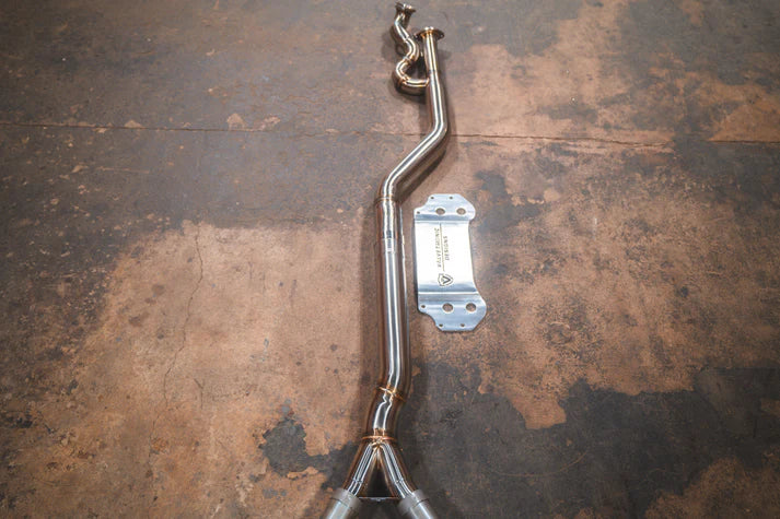 A performance exhaust system midpipe for a BMW G87 M2, made of stainless steel or titanium, displayed on a metallic surface.