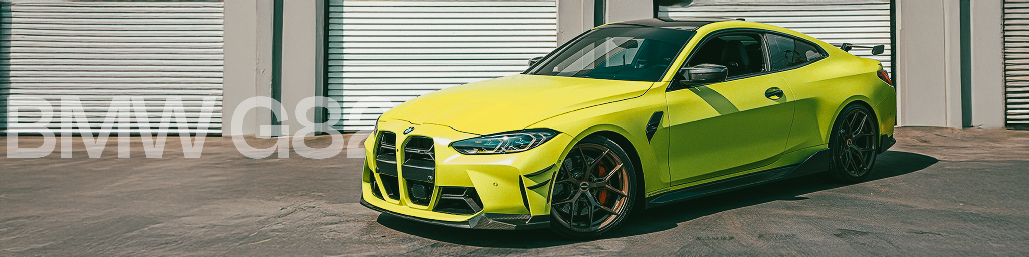 Lime green BMW car parked in front of a white garage door.