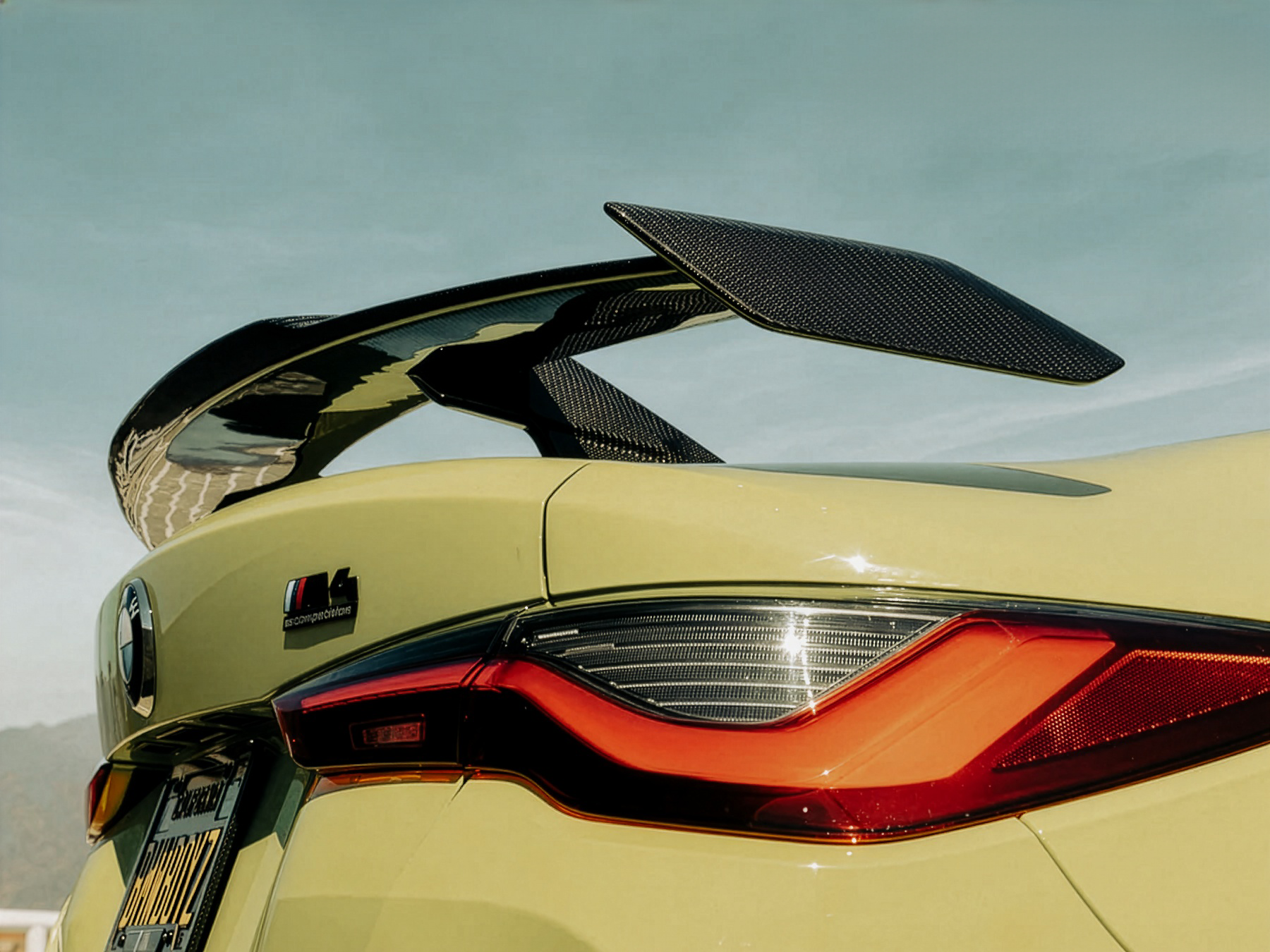 Car spoiler with a clear sky background